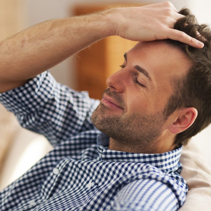 Smiling man with hand in hair